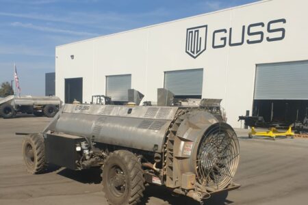 Automated agricultural sprayer parked outside a GUSS facility